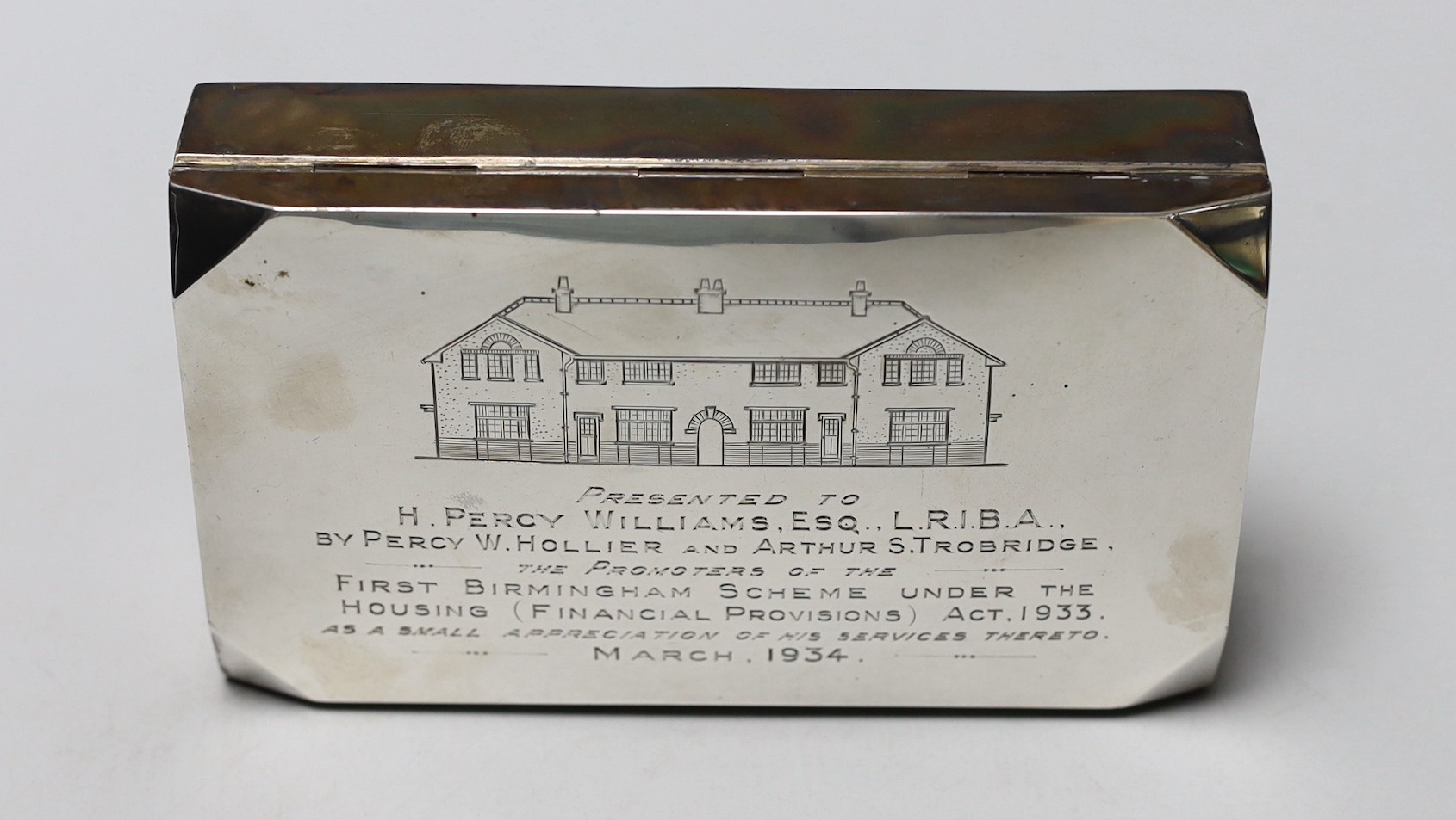 A George V silver mounted rectangular cigarette box, with engraved inscription, 14.7cm.
